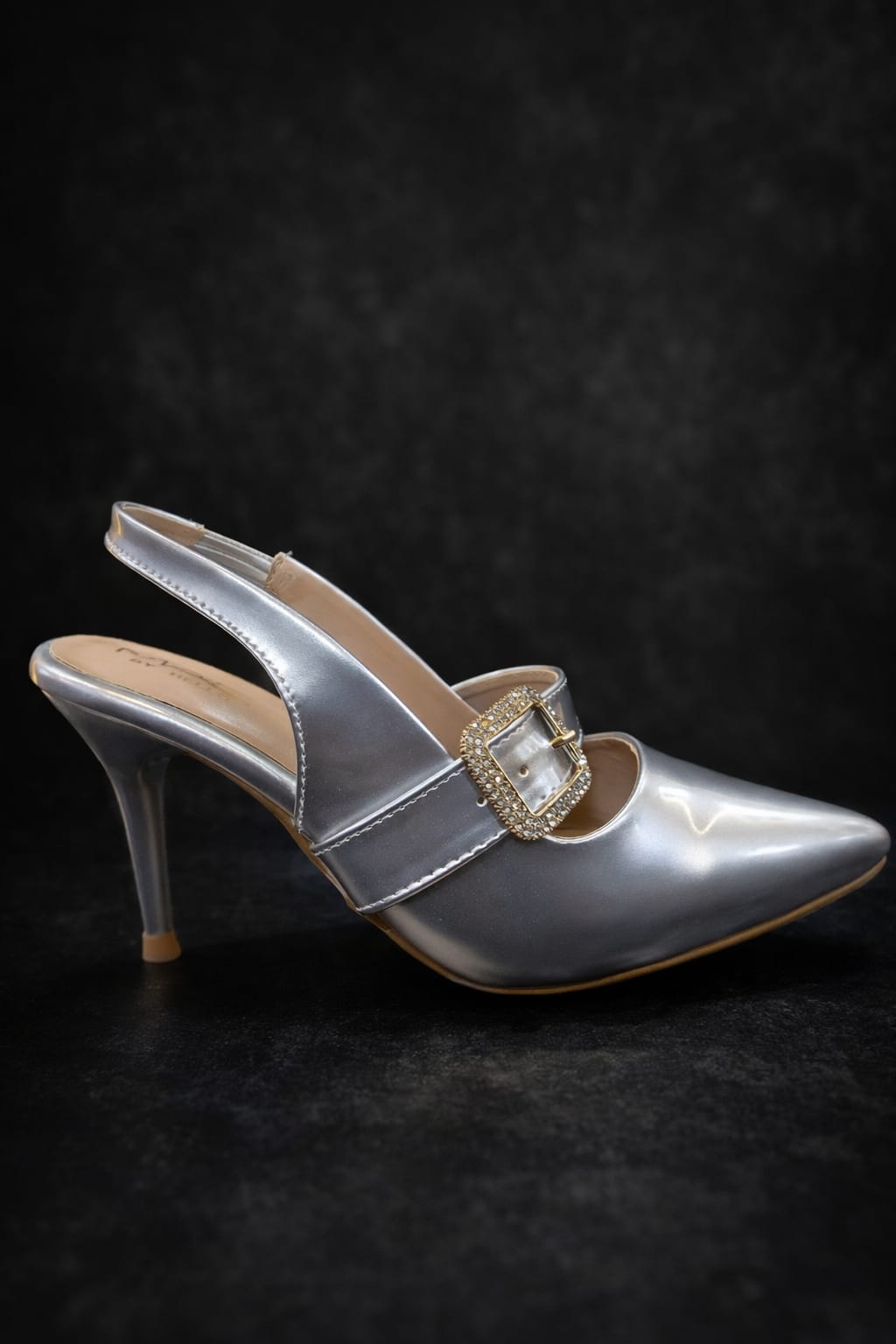 women’s gold and silver pointed-toe heels