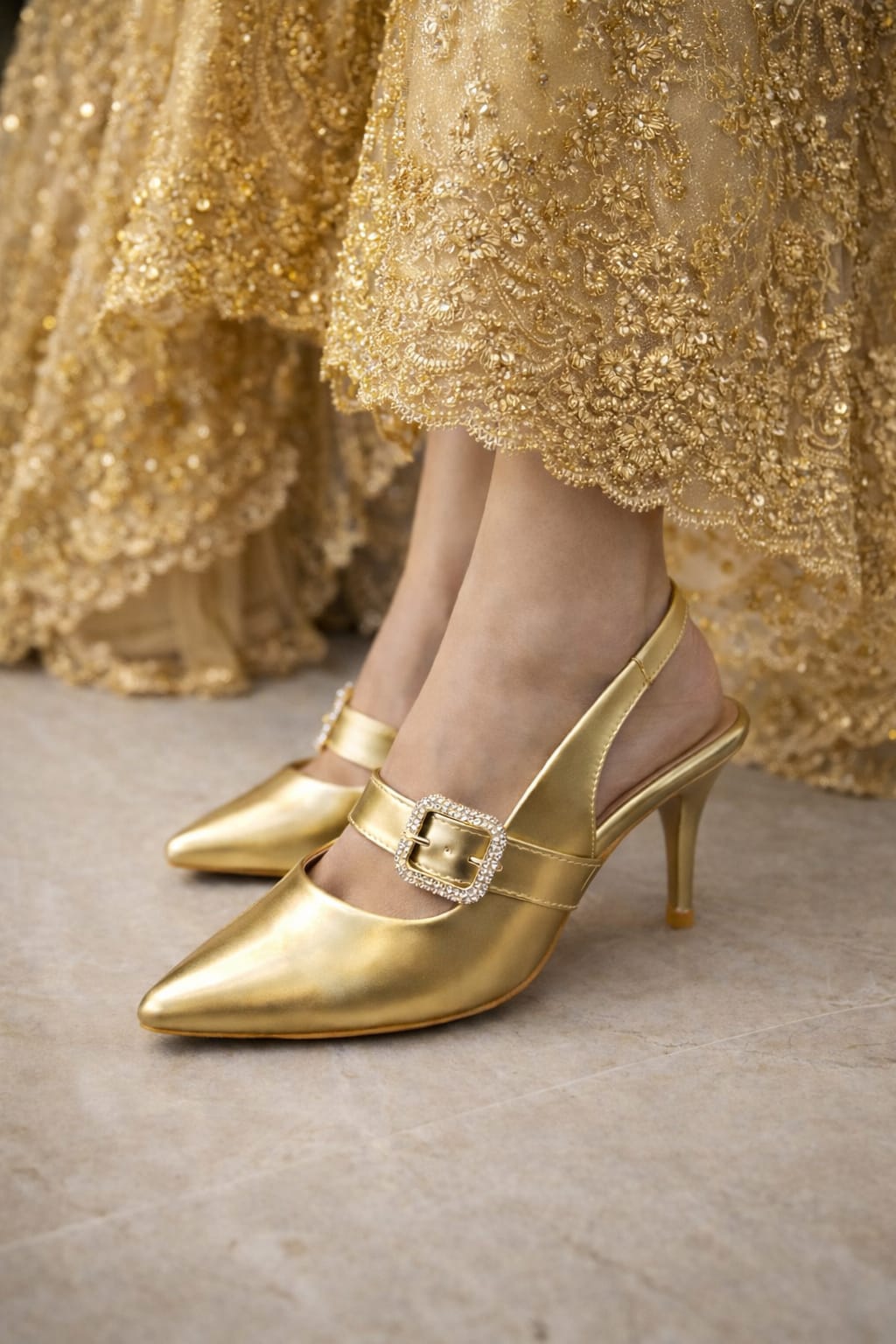 women’s gold and silver pointed-toe heels